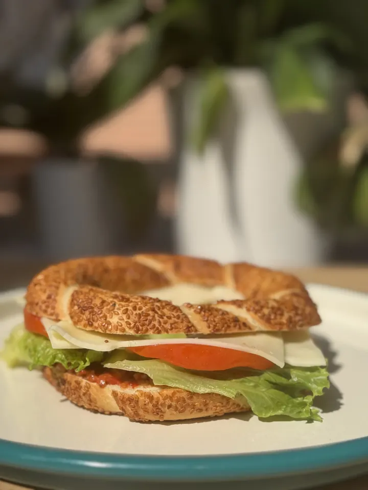 A simit, the sesame crusted Turkish bread ring, split and filled with cheese, tomato, lettuce and onion at Berna's Bakery & Cafe in Issaquah